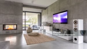 Tv living room with window, fireplace and concrete wall effect